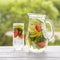 Dietary detox drink with lemon juice, red strawberry, cucumber and mint leaves in clear water with ice.