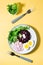 A dietary dish made from vegetables. Beet tartare, radish, frieze salad and boiled egg on a plate and a fork