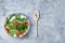 Dietary mixed salad in glass sultana served with wooden spoon on white background, selective focus