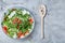 Dietary mixed salad in glass sultana served with wooden spoon on white background, selective focus