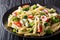 Dietary pasta Casarecce with vegetables dressed with creamy cheese sauce close-up on a plate. horizontal