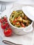 Dietary pasta with spinach, zucchini and cherry tomatoes