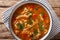 Dietary Polish meal flaczki with vegetables in tomato sauce close-up in a bowl. Horizontal top view