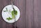 Dieting concept - white plate with dill, salad lettuce, basil and centimeter tape