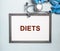 Diets word in doctor hands, dieting concept