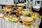 Diferrent peanuts, cheese, meat and salads on wedding reception.
