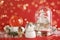 Different beautiful snow globes and Christmas decor on red background. Bokeh effect