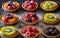 Different berry tarts on light table. Delicious pastries.