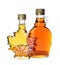 Different bottles of tasty maple syrup on white background