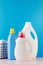 Different bottles with washing gel on a blue background. The concept of laundry, washing, household chemicals.