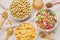 Different breakfast cereals and honey on napkin, flat lay