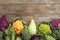 Different cabbages on wooden table, top view