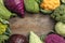 Different cabbages on wooden table, top view