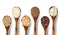 Different cereals and beans on wooden spoons