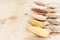 Different cereals grain in spoons on beige wood board, rustic background.