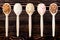 Different cereals grain in wooden spoons against wooden background. Top view of groats assortment, healthy food and eating