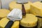 Different cheese on a tray round and square with cheese slicer,