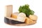 Different cheeses and a bunch of parsley lying on a board isolated on white background