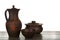 Different clay dishware on wooden table against white background