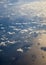 Different clouds below, view from a plane