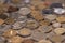 Different coins on wooden tabletop, pile of coins concept