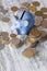 Different collector coins and piggy bank on the wooden background