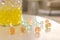 Different color fillers and glass vase on white table in room, closeup. Water beads