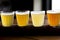 Different color wheat beer varieties in small glasses for sampling