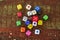 Different colored game dices on a wooden table