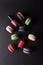 Different colored macarons and nail polishes