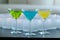 Different colored martinis with candles