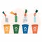 Different colored trash cans with paper, plastic, glass and metal waste suitable for recycling