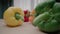 Different colored wet bell peppers with green peduncles