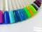 Different colorful nails polish manicure palette Background. Samples of nail varnishes. False Display Nail Art Fan Wheel Polish Pr