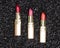 Different colors of lipstick on anthracite background