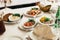 Different cooked dishes and snacks on a white table