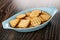 Different cookies in oval bowl on wooden table