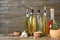 Different cooking oils in bottles on wooden table