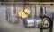 Different cooking utensils hung up on a metal wall in the kitchen of a pizza shop