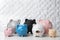 Different cute piggy banks on table