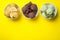 Different delicious ice creams on yellow background, flat lay. Space for text