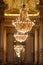 Different details of a luxurious theater with gold touches and stained glass