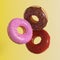 Different donuts fly on a yellow background