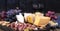 Different Dutch cheese. Ham, grapes, olives and snacks. Free space for text. copy space.