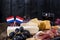 Different Dutch cheese. Ham, grapes, olives and snacks. Free space for text. copy space