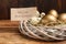 Different eggs and card with phrase Pension Investments in nest on wooden table, closeup