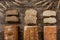 Different fresh bread and spikelets of wheat on rustic wooden background. Creative layout made of bread.