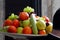 Different fresh fruit in the bowl on the table, ready to be eaten