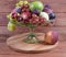 Different fruits in glass fruit vase on old rustic table