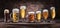 Different glasses of beer on the wooden table.